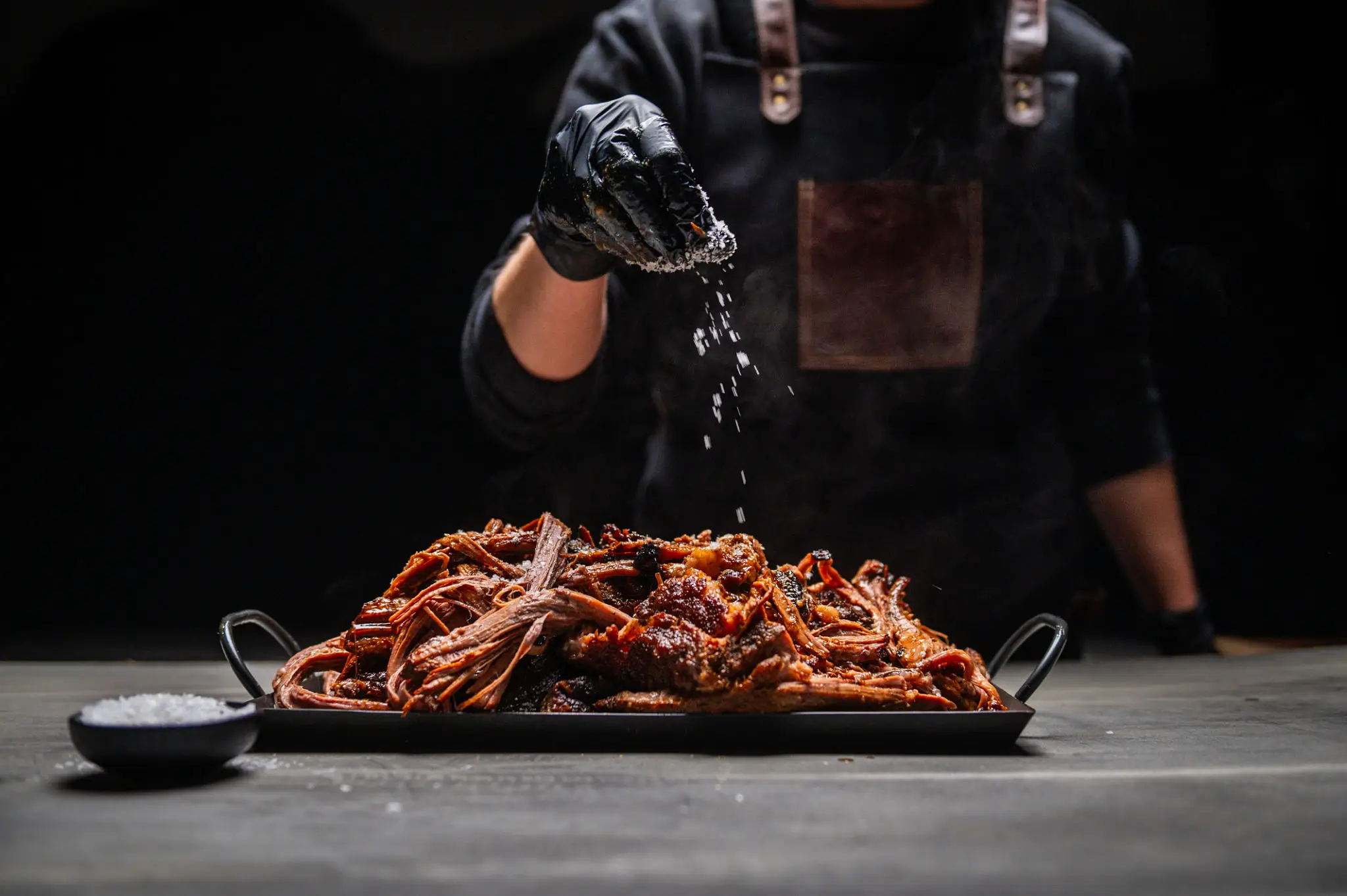 Chef sprinkling salt over seafood platter