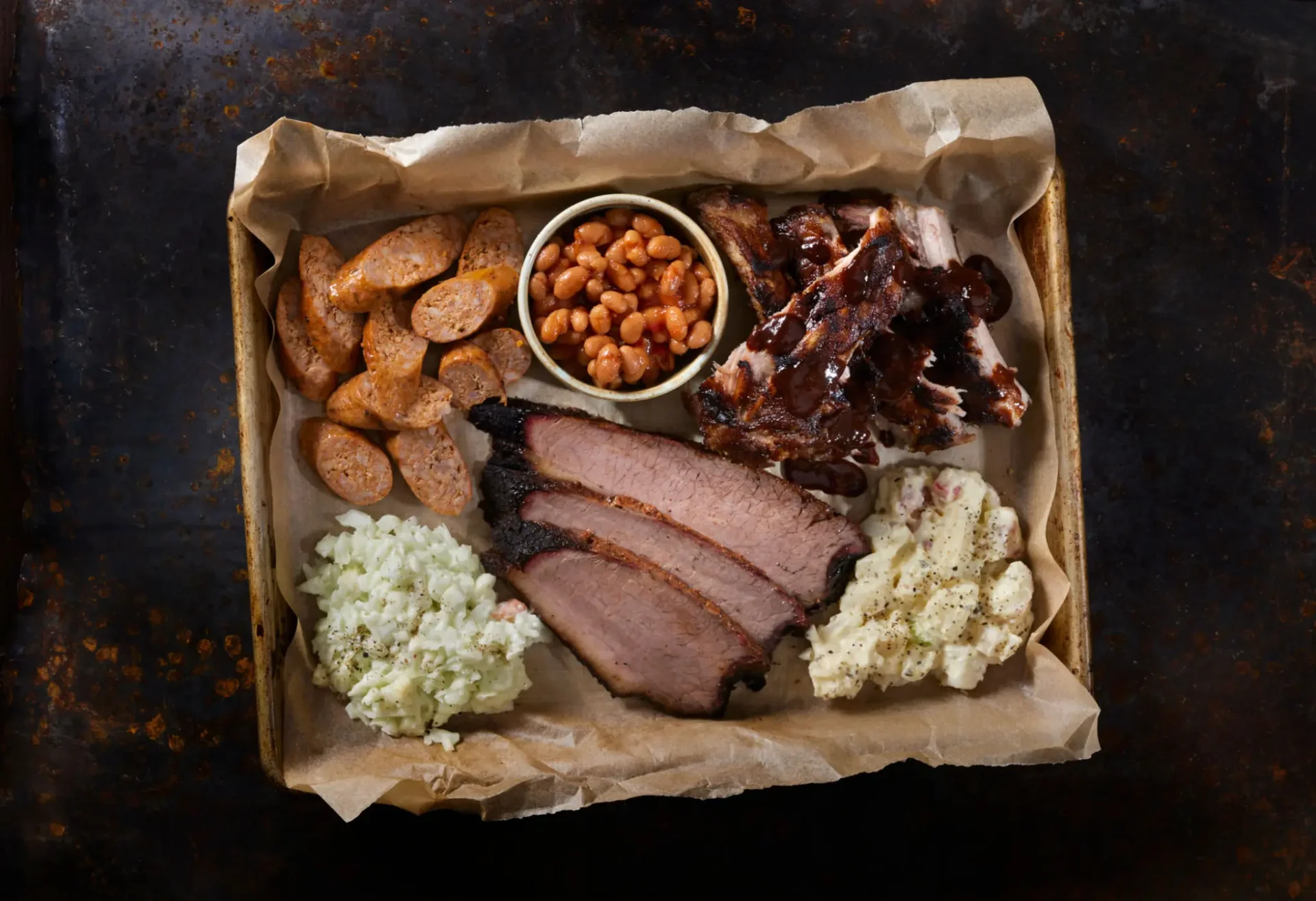 Barbecue platter with smoked brisket, ribs, sausage